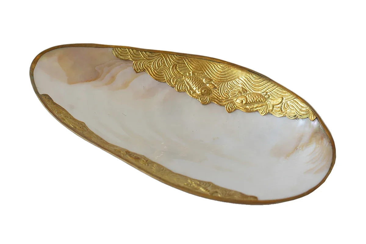 Decorative plate with gold edge and shell pattern on a white background