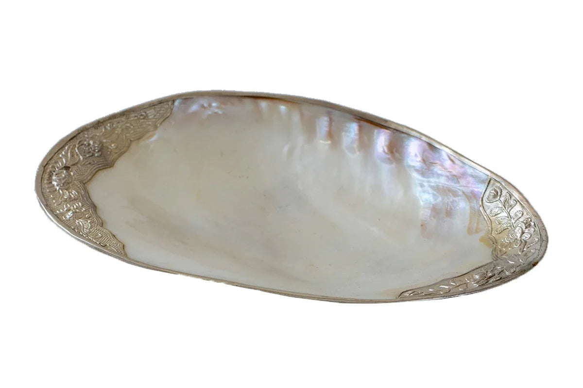 Shell dish with silver edge on a white background